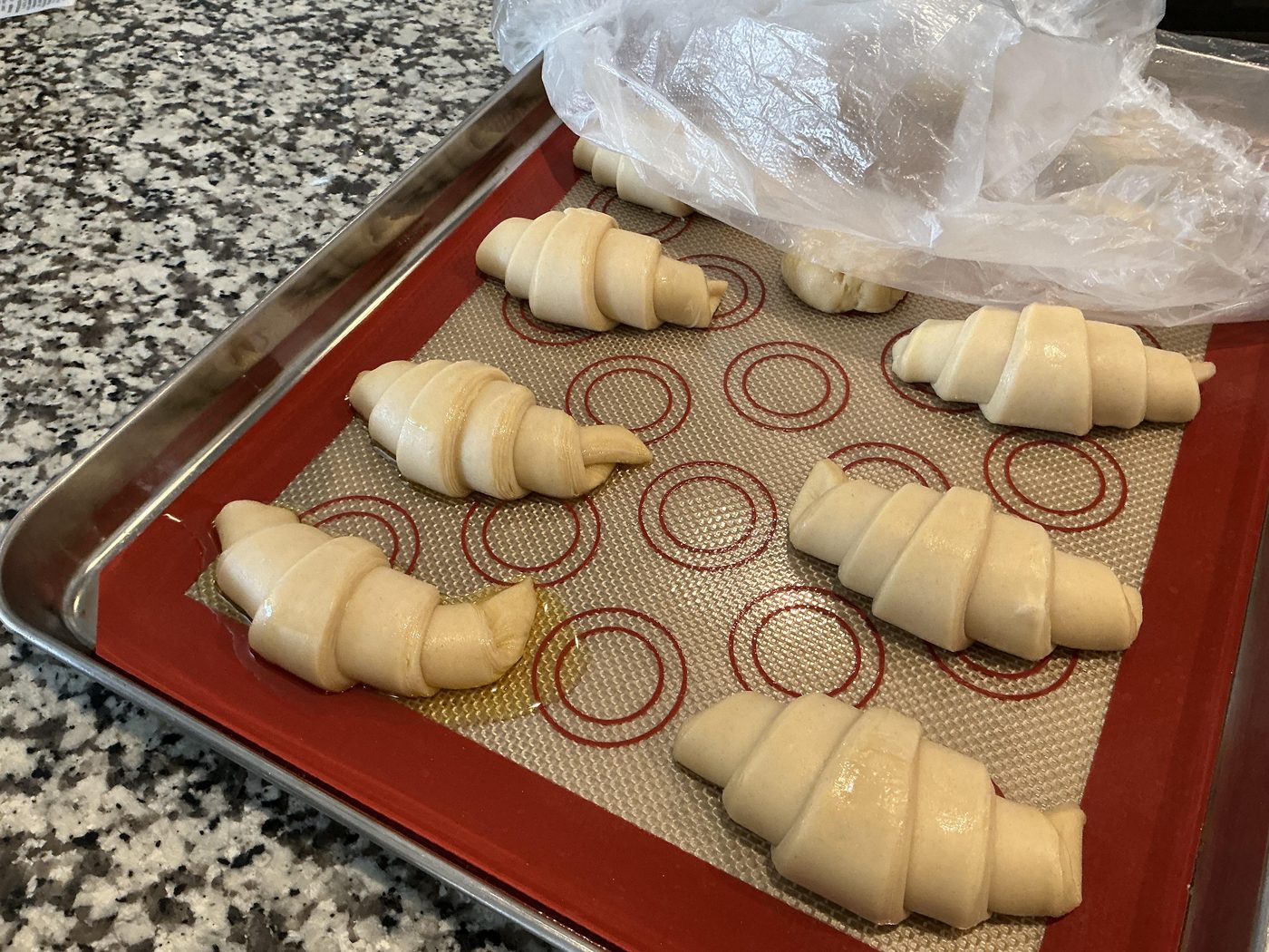 Ann Snow's shaped croissants proofing on a silicone mat and baking sheet